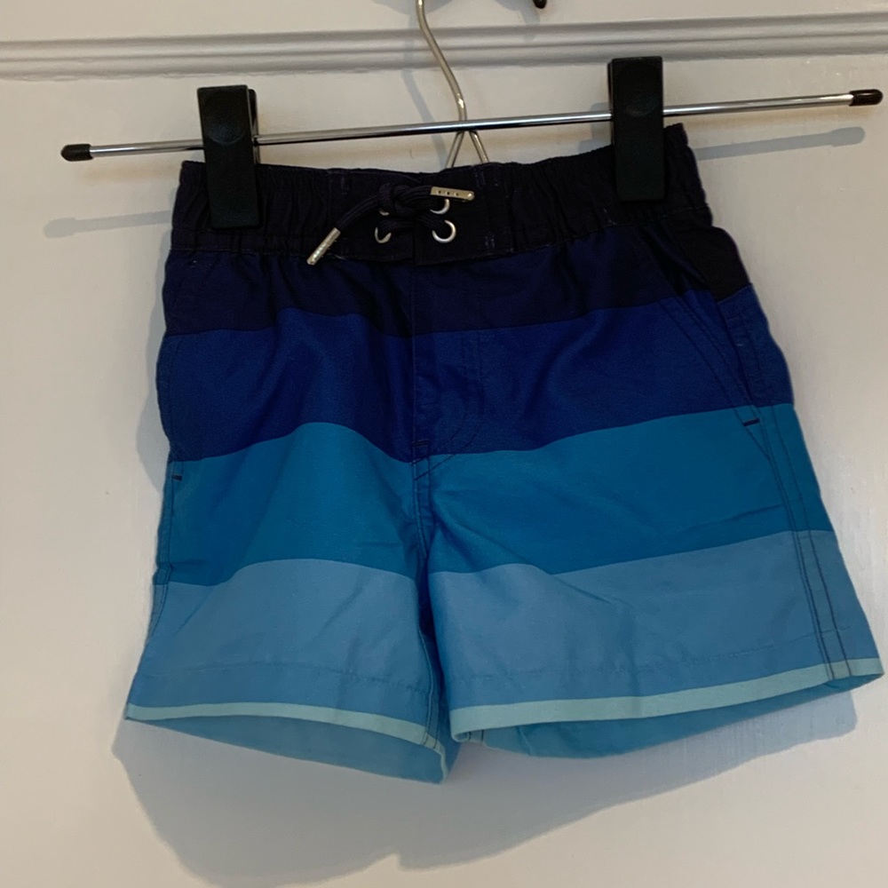 Primary blue striped swim trunks NWOT 6-12m